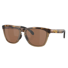 OAKLEY sunglasses with a brown tortoiseshell acetate frame and brown tinted lenses, shown on a light gray background with a soft reflection.