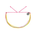 Neon pink, yellow, and pink bracelet with a black logo charm on a white background