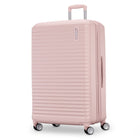 Pink suitcase with a ribbed texture on a white background
