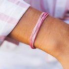 model wearing Pura Vida Boarding 4 Breast Cancer Charity Bracelet