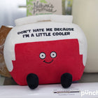 Plush toy with a message on it, sitting on a surface.