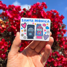 Model holding Santa Monica Magnet - Houses