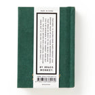 Green book with a label on a white background