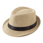 A light beige straw fedora hat with a black band around the crown, shown on a plain white background.