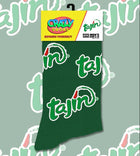 A pair of green crew socks with a repeating white Tajik script pattern, shown on a white background alongside their retail packaging. The packaging features a yellow and white header with the 'Crazy Socks' brand logo and the name 'tajik'.