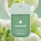 Touchland hand sanitizer bottle with a floral background