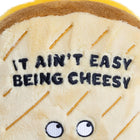 Plush toy resembling a cheese wedge with embroidered text and eyes.