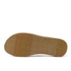 Brown sole of a shoe with tread pattern on a white background