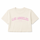 An off-white cropped short-sleeve t-shirt with 'LOS ANGELES CALIFORNIA' printed in pink on the front, displayed against a solid white background.