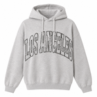 A light heather gray pullover hoodie with 'LOS ANGELES' printed across the chest in a large arched outline font with a distressed black-and-white pattern.