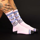 Pink socks with text worn by a person on a black background