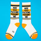 White socks with black and yellow text on a blue background