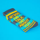 Pair of socks with humorous text on a blue background