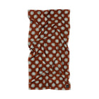 Brown fabric with white floral pattern on a white background
