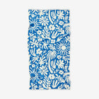 Blue towel with white floral pattern on a white background