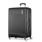 A black hardshell spinner suitcase with a vertical ribbed design, telescoping handle, and four wheels, shown on a plain white background.