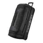A black Samsonite rolling duffel bag with an extended telescoping handle, shown at a three-quarter angle on a clean white background.