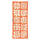 Orange towel with white floral patterns on a white background