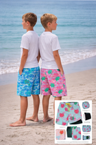 Two boys standing on a beach wearing colorful swim shorts with a inset showing the designs.