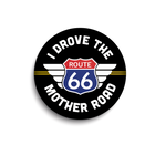 Round black sticker with Route 66 logo and text on a white background