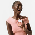 Model holding Velvet Peach Power Mist Hydrating Hand Sanitizer