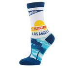 A single crew sock featuring a Los Angeles beach sunset design. The sock has a white upper section with a blue cuff and 'Anaheim's' text, a yellow sun and red 'CALIFORNIA' stripe, and a blue and light blue palm tree beach graphic at the bottom.