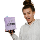 Person holding a purple book with text and a surprised expression on a white background
