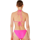 Person wearing a bright pink bikini against a white background