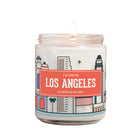 lit jar candle with a white wax body and a colorful illustrated label that reads 'I LOVE LOS ANGELES.' The background is a clean white studio backdrop.