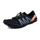 A black water shoe with gray reflective straps, lime green laces, and an orange heel accent, shown against a plain white background.