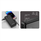 Black multi-port charging adapter with smartphone and phone case on a white background