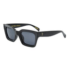 Black sunglasses with gold accents on a white background