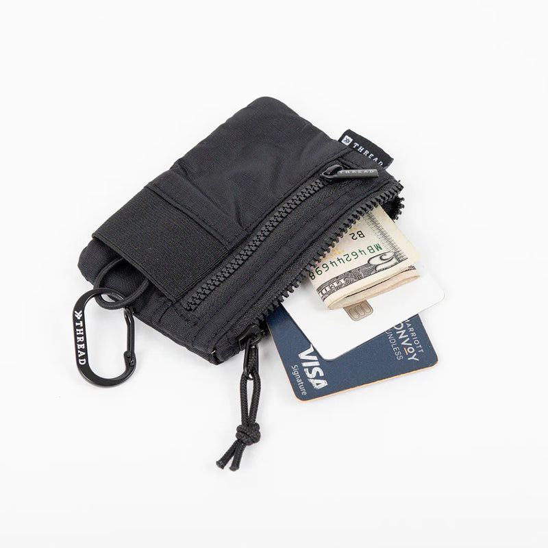 Black wallet with money and card on a white background
