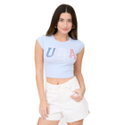Woman wearing a light blue crop top with 'USA' text and white shorts on a white background