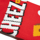 Close-up of a red sock with white text and yellow accents