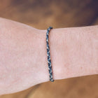 Model wearing Pura Vida Mini Braided Steel Bracelet