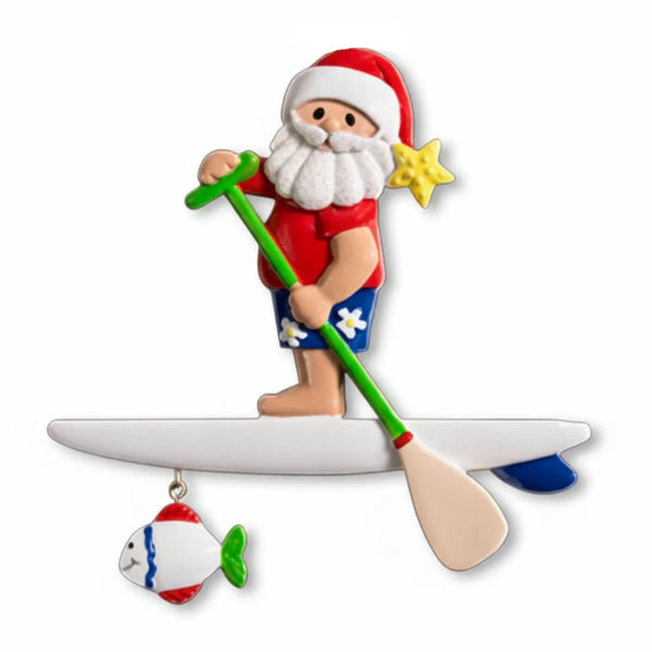 Santa Claus character on a surfboard with a paddle and fish ornament on a white background