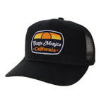 A black trucker-style cap with a curved brim and a front patch reading 'Santa Monica California' with a sunset graphic, photographed on a clean white background.