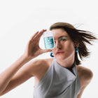 Model holding Blue Sandalwood Power Mist Hydrating Hand Sanitizer