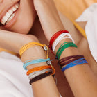 Model wearing multiple pura vida bracelets