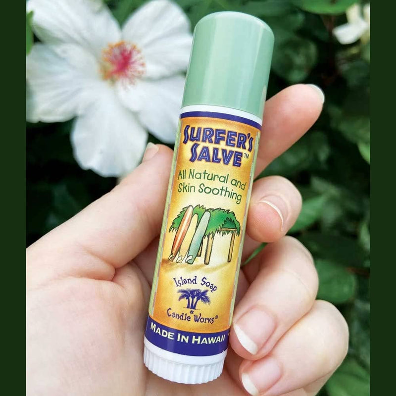 Model holding All Natural Surfer's Salve - .5 oz. Stick