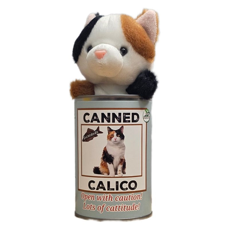 Plush toy cat inside a can labeled 'Canned Calico' on a white background