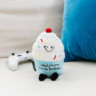 Plush toy resembling a cupcake with text on a light background