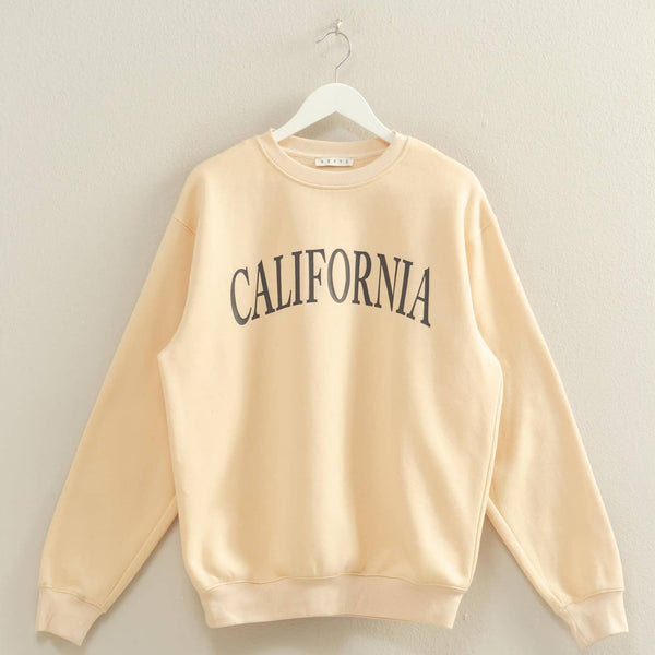 Beige sweatshirt with 'CALIFORNIA' text on a hanger against a plain background