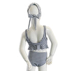 Mannequin wearing a black and white checkered swimsuit with matching headband on a white background