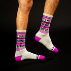 White socks with pink and black text on a black background