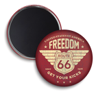 Two round refrigerator magnets shown on a white background, one displaying the front design and the other showing the magnetic backing. The front magnet features a distressed red background with a vintage Route 66 shield emblem and the text 'FREEDOM', 'ROUTE 66', and 'GET YOUR KICKS'.