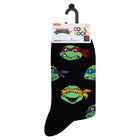 Black sock with green turtle faces on a white background