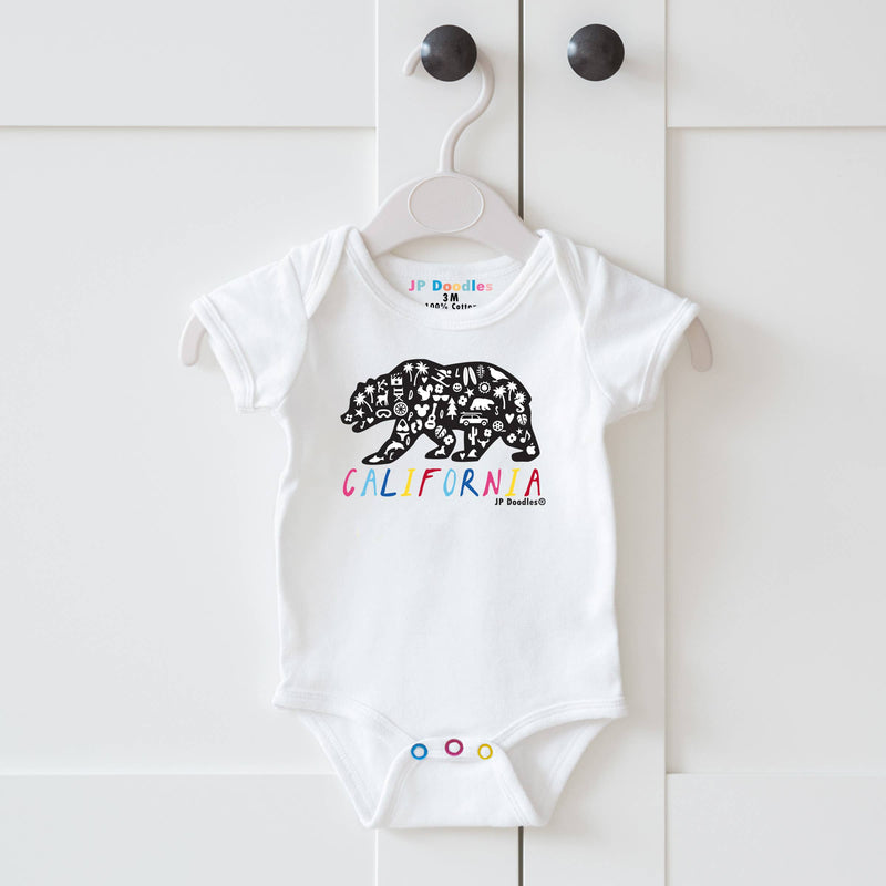 White baby onesie with bear design and 'California' text on a hanger against a white background