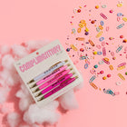 Set of pink pens with gold accents on a pink background with colorful paper clips.